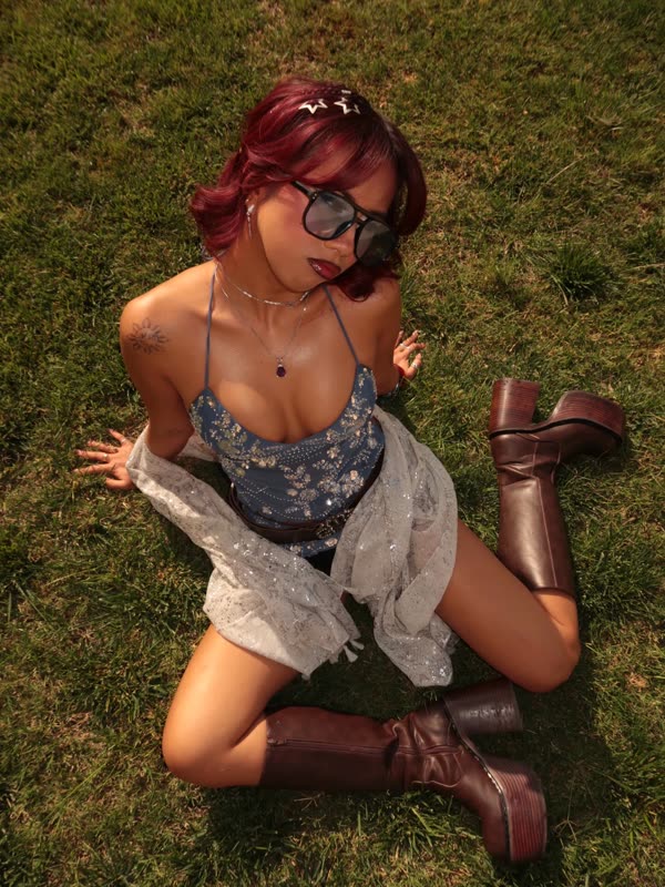 On the grass in boots and sunglasses