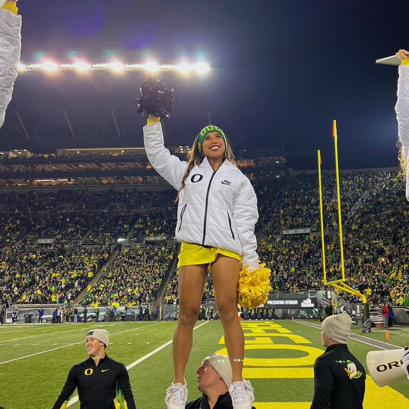 Held up over the sideline, one arm raised